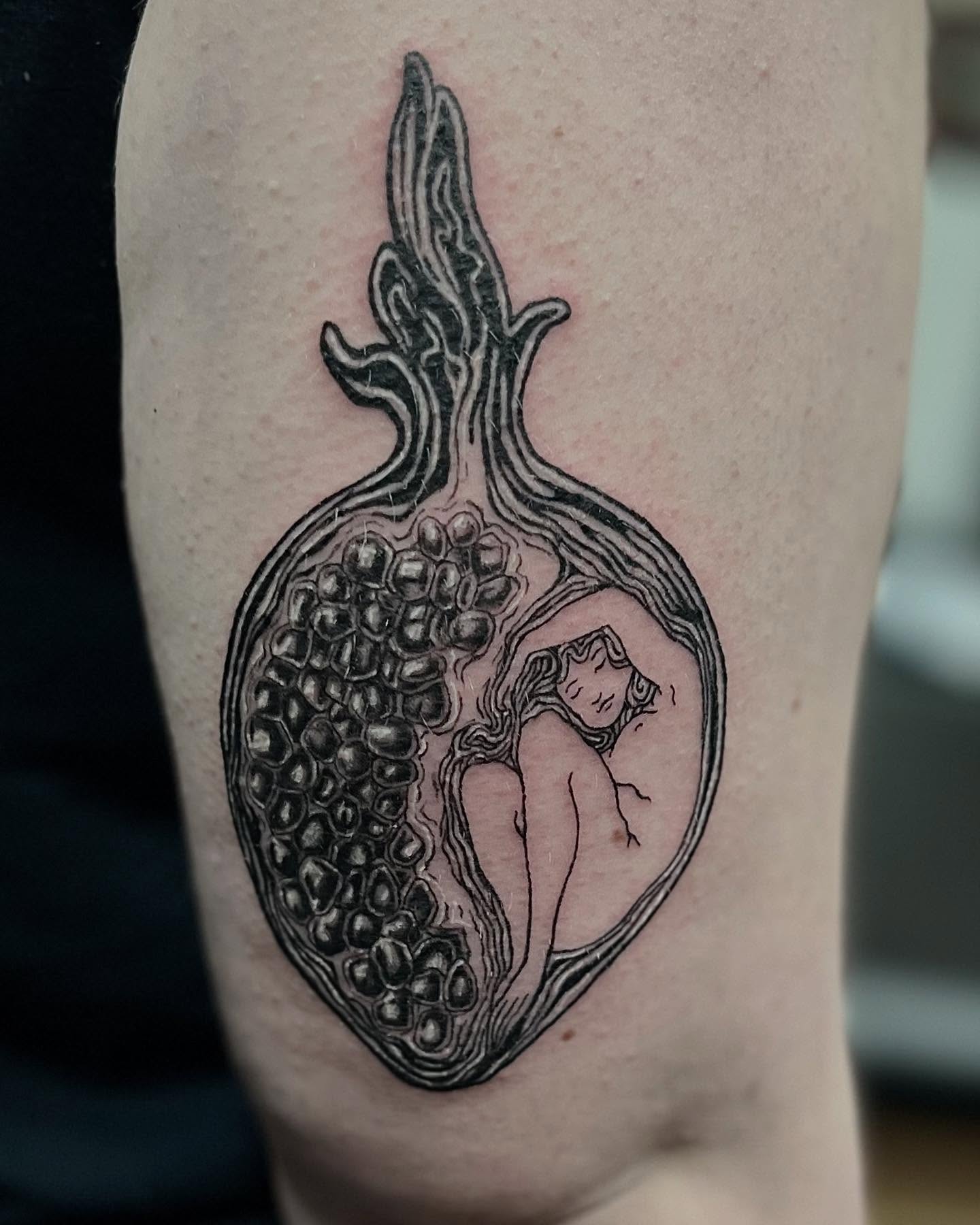 Pomegranate and woman realism tattoo on the forearm by Tattoo Artist