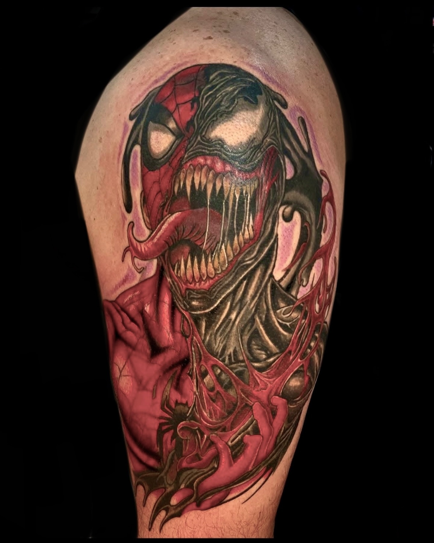 Venom dark realism tattoo on the forearm by Kenny Buck