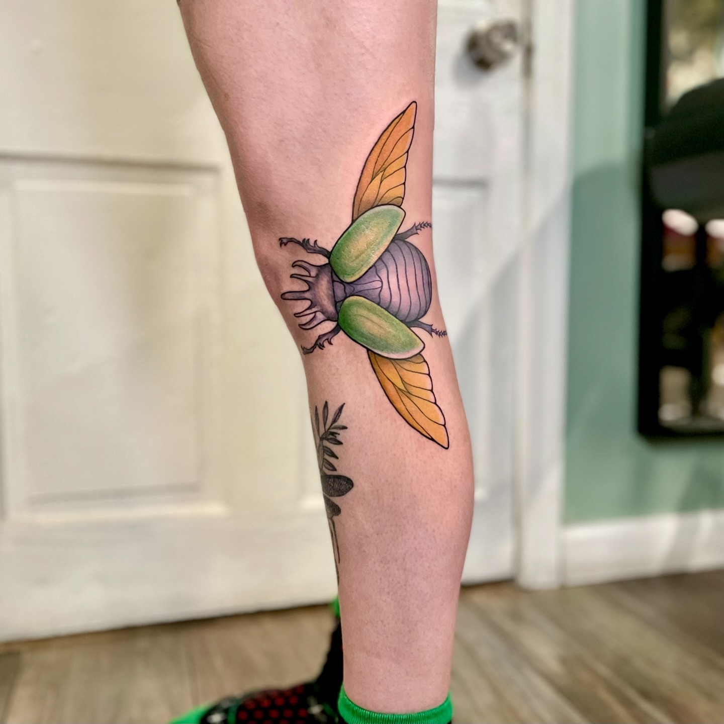 Scarab beetle American traditional tattoo on the calf by Liv