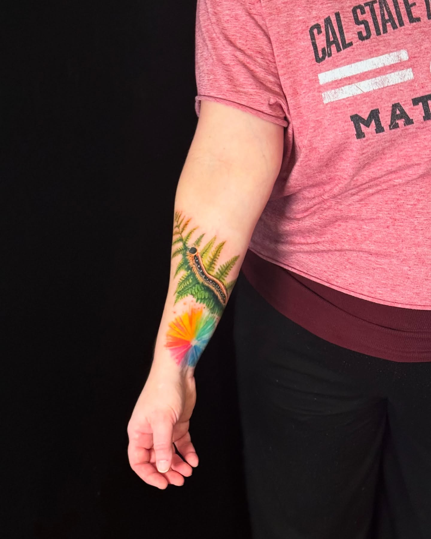 Flower and caterpillar new school tattoo on the forearm by Ksu Storm, San Francisco, California