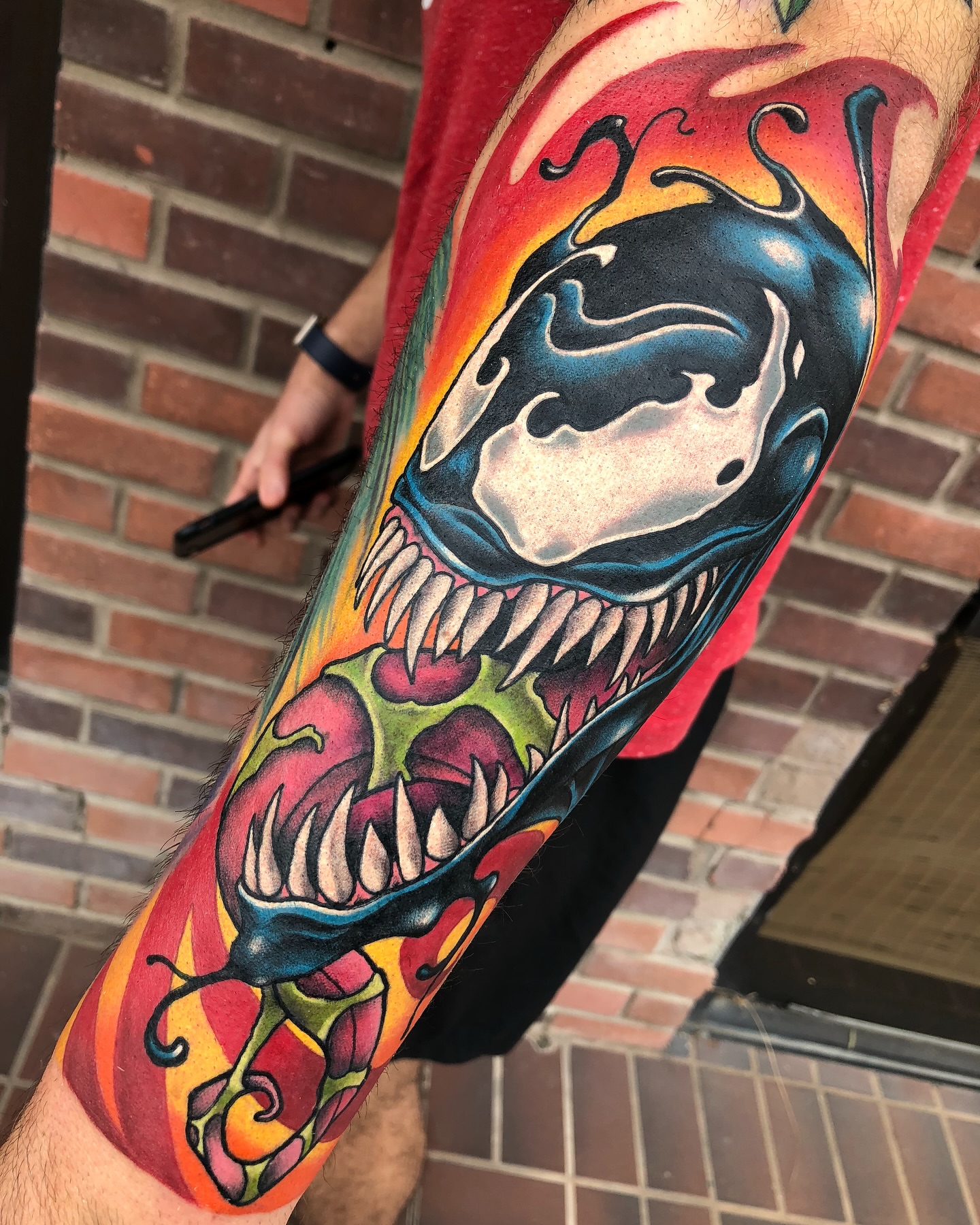 Venom-inspired skull American traditional tattoo on the forearm by James Mullin