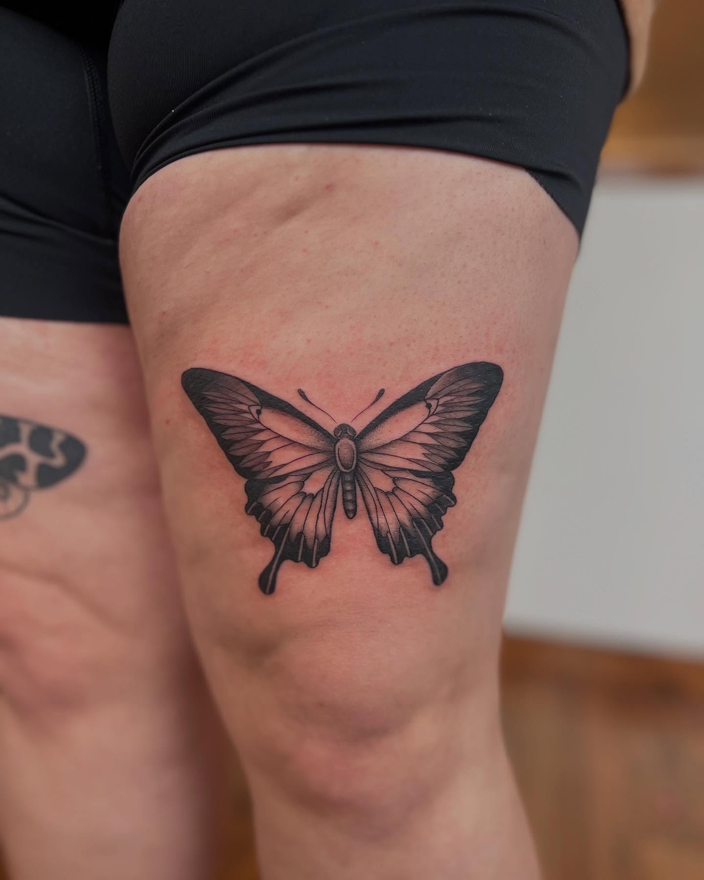 Butterfly black and grey tattoo on the thigh by Tasha Venola, Bellingham, Washington
