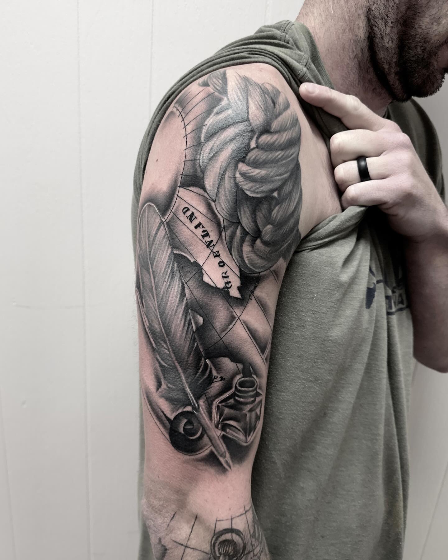 Winged angel realism tattoo on the upper arm by Kat Garcia