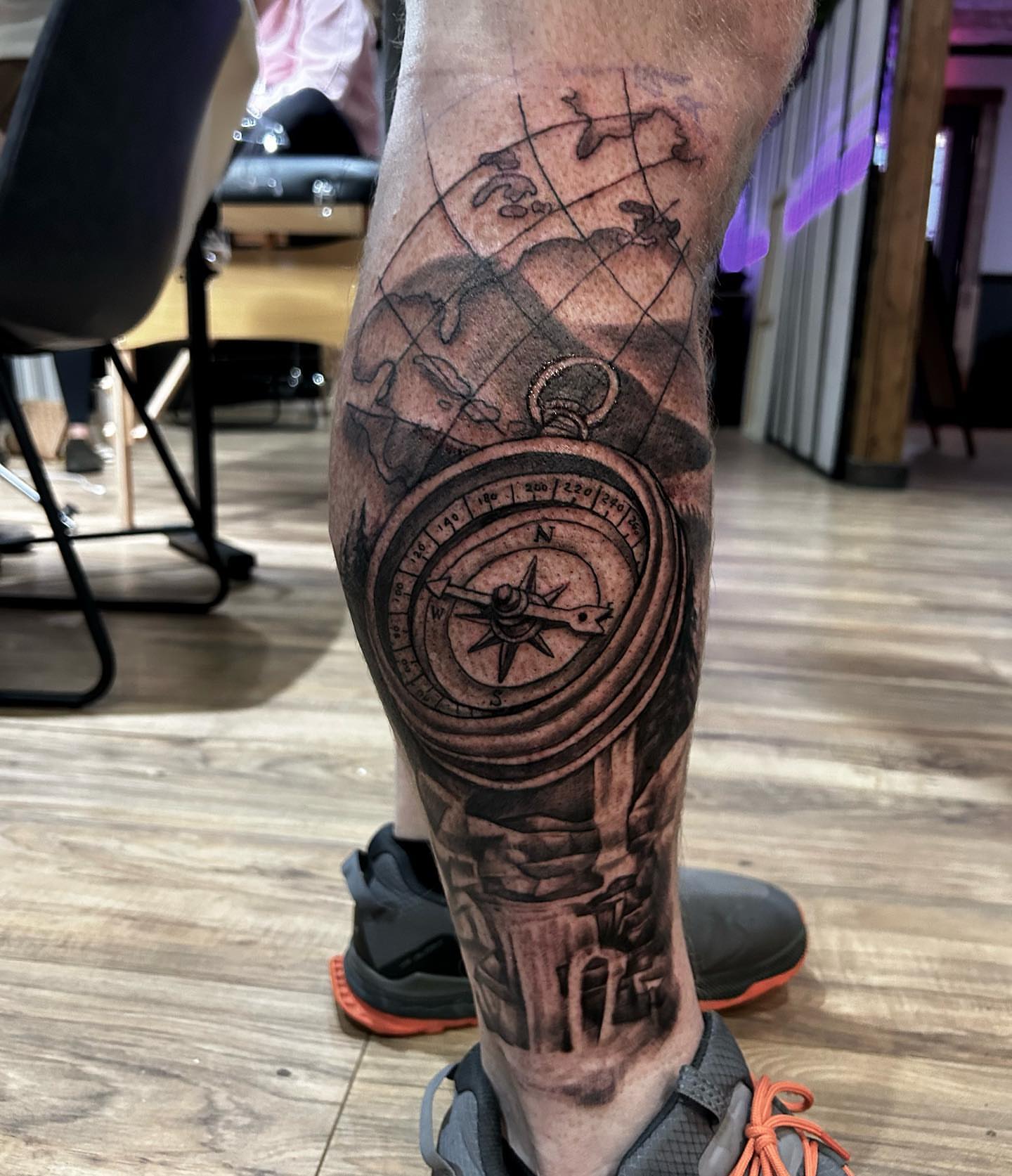 Compass and globe realism tattoo on the calf by Cody Lambert