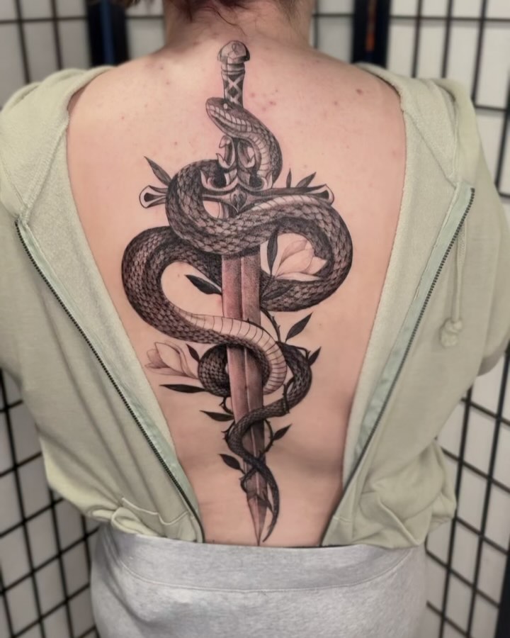 Snake and dagger realism tattoo on the back by jordyn ๐ญ
