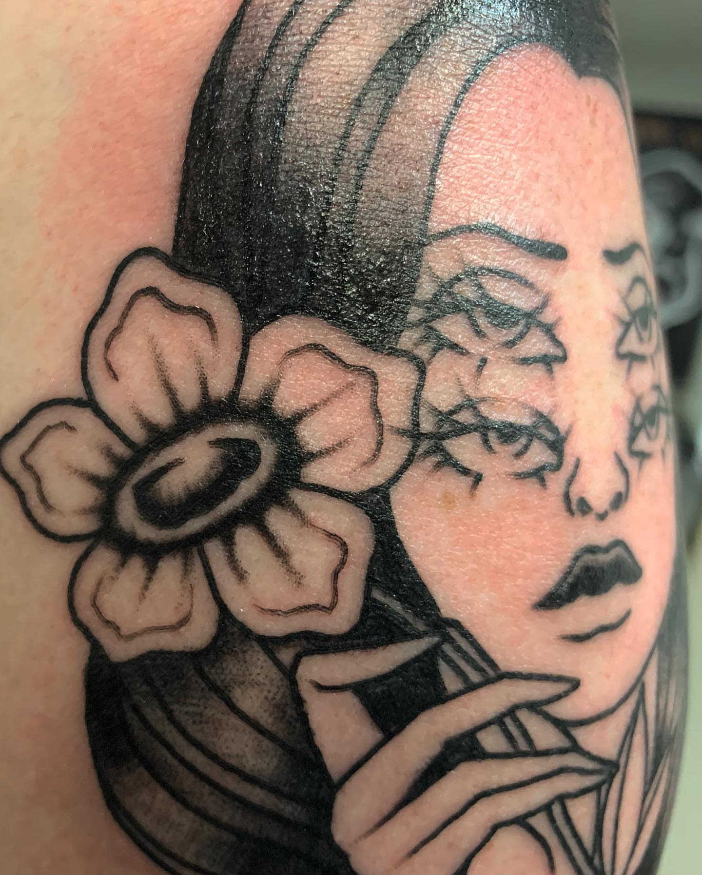 Woman with flower black and grey tattoo on the forearm by Brii Moser