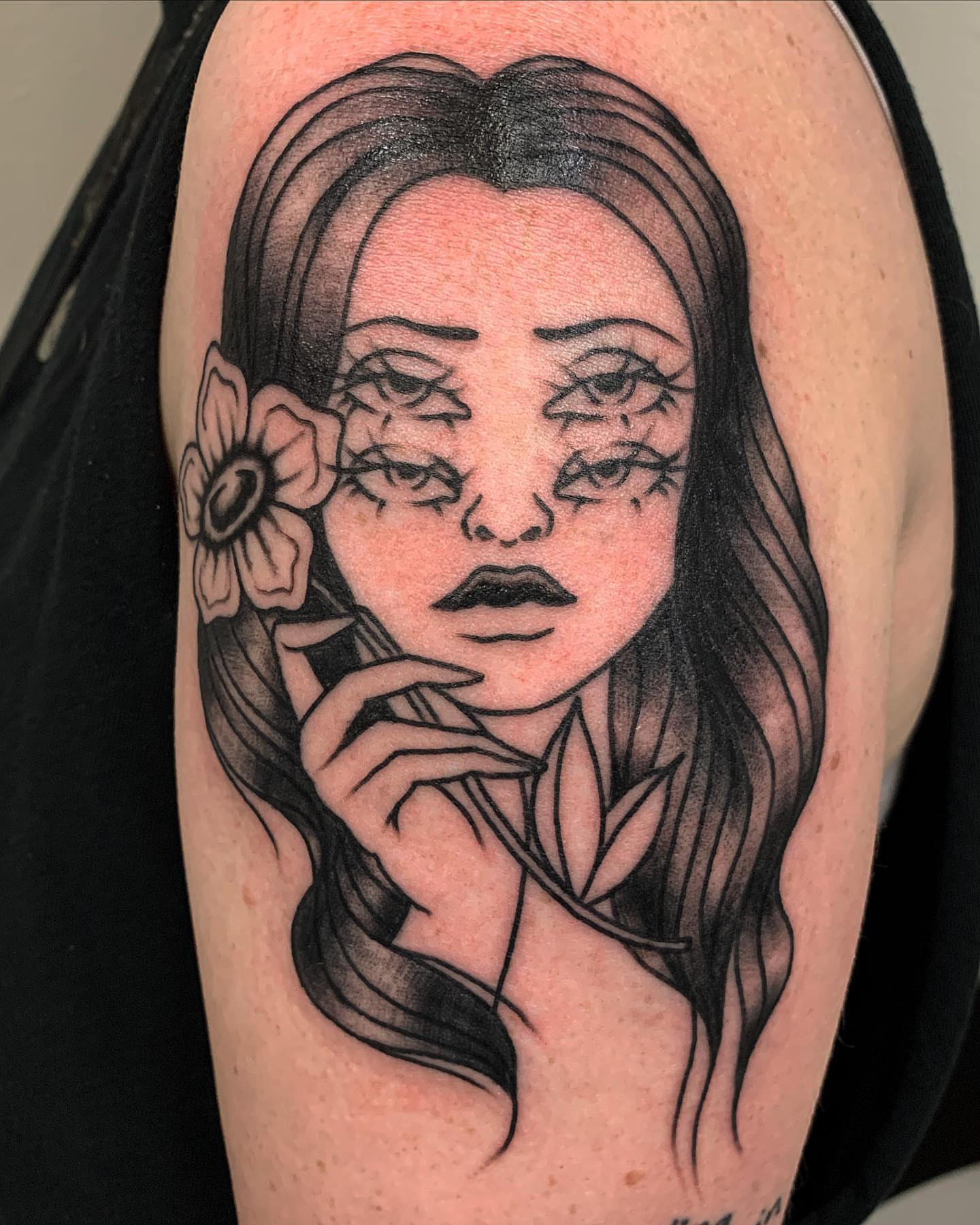 Woman with flower realism tattoo on the shoulder by Brii Moser