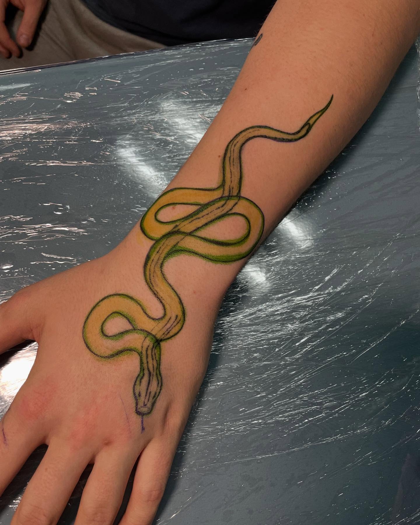 Snake realism tattoo on the hand by Candence Smith