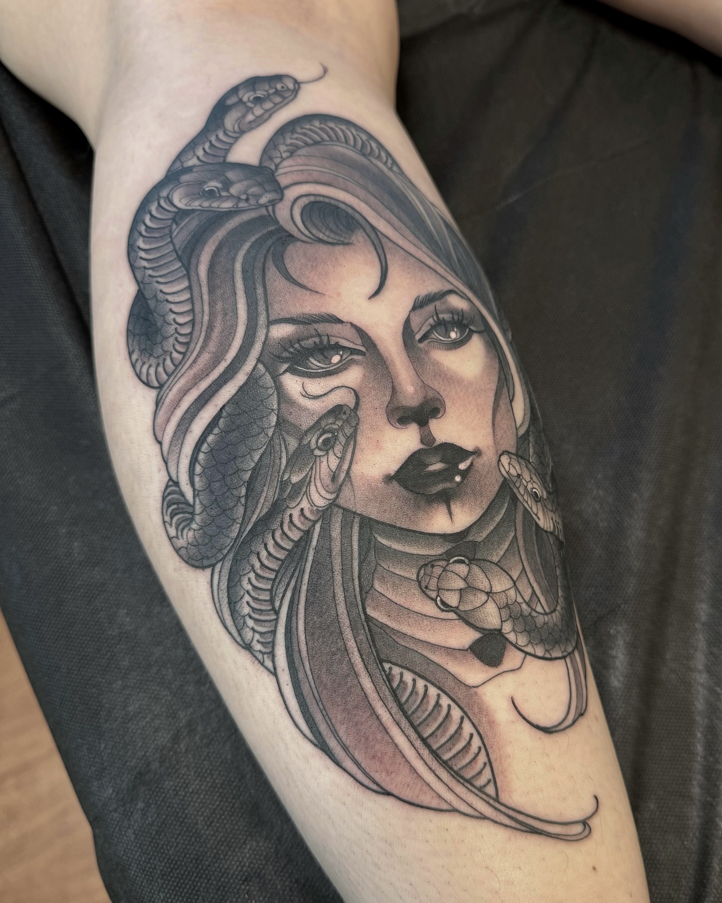 Woman with snakes realism tattoo on the forearm by Anne Cornelson