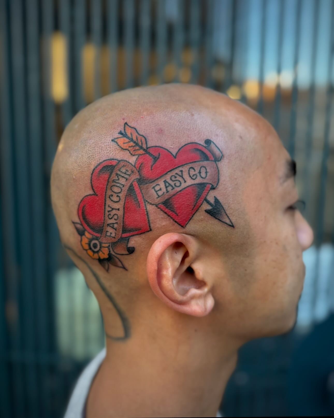 Heart with arrow American traditional tattoo on the head by Micah Norman, San Francisco, California