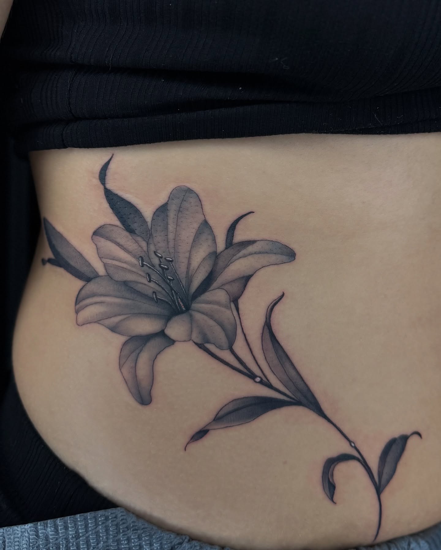 Lily black and grey tattoo on the ribs by Chris_Tatt2_D’Ascenzo