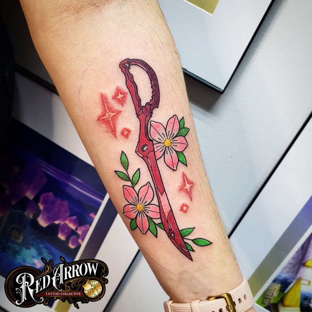 Scissors and flowers new school tattoo on the forearm by 𝕽𝖊𝖉 𝕬𝖗𝖗𝖔𝖜 𝕿𝖆𝖙𝖙𝖔𝖔 𝕮𝖔𝖑𝖑𝖊𝖈𝖙𝖎𝖛𝖊, Troy, Michigan