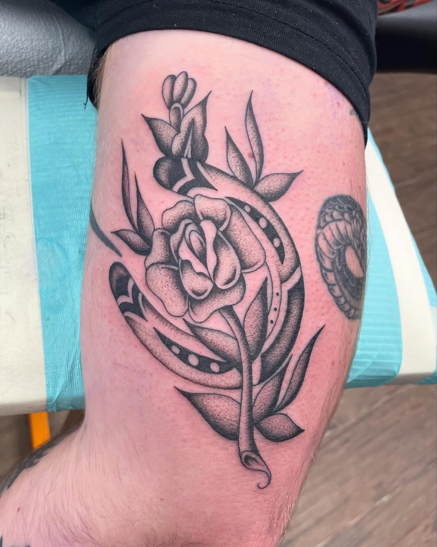 Rose and snake American traditional tattoo on the thigh by Brayden P Tattoo