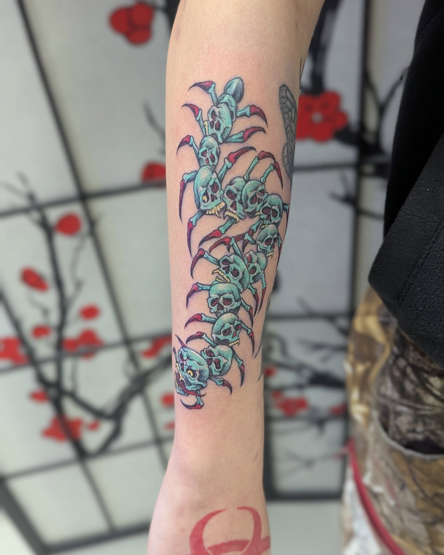Skulls and claws trash polka tattoo on the forearm by Claudia Isabel Roman, El Paso, Texas