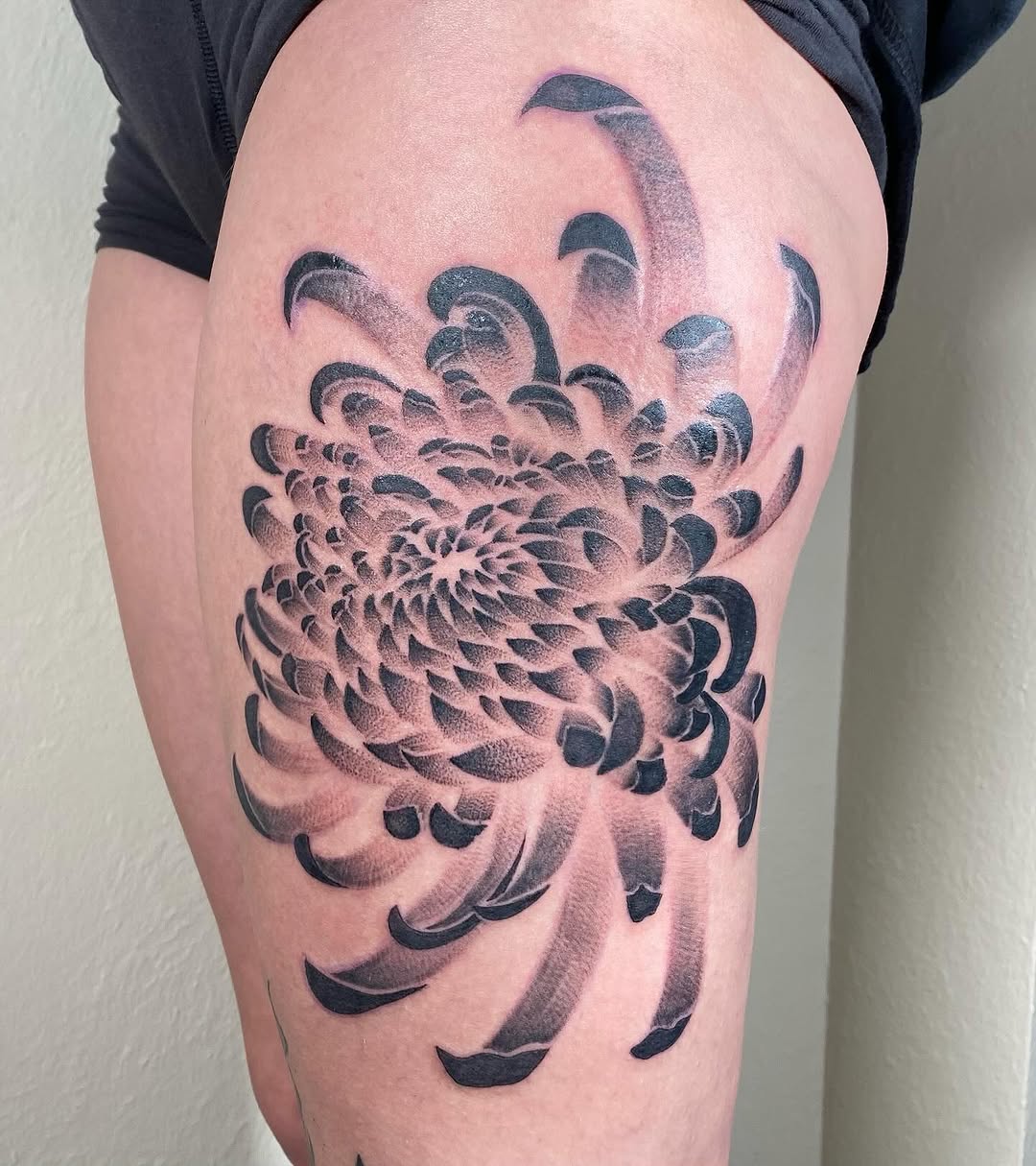 Chrysanthemum flower dotwork tattoo on the thigh by Jenna Nicole