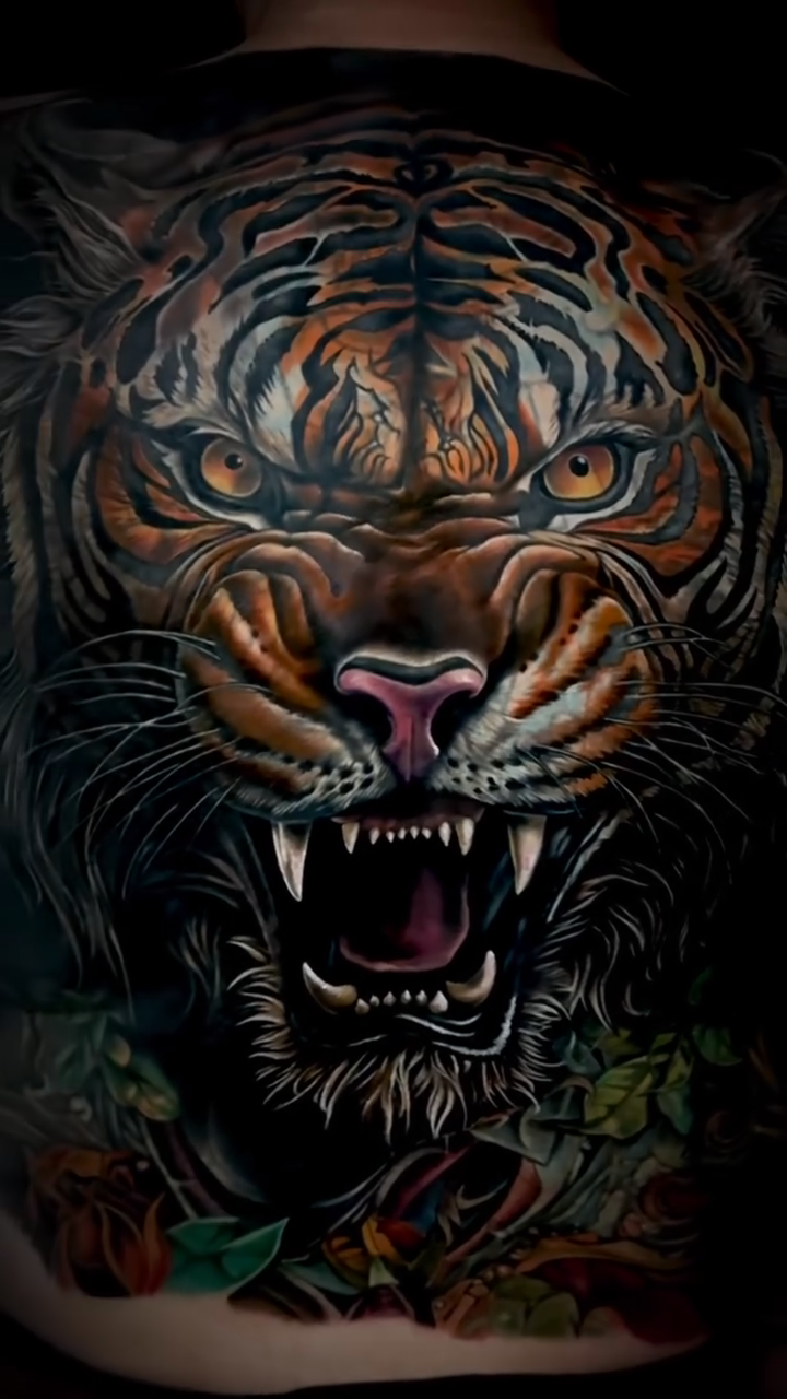 Tiger with floral elements realism tattoo by Noelin Wheeler