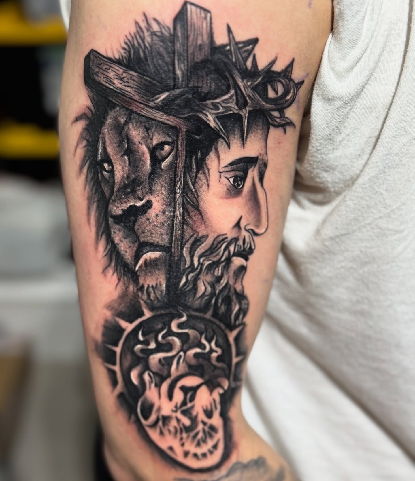 Lion and jesus realism tattoo on the forearm by Therapy ink