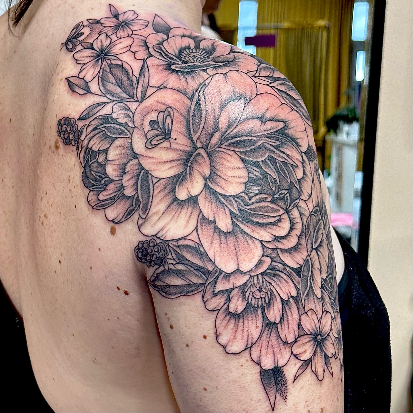 Floral bouquet black and grey tattoo on the shoulder by Emily K Lingg