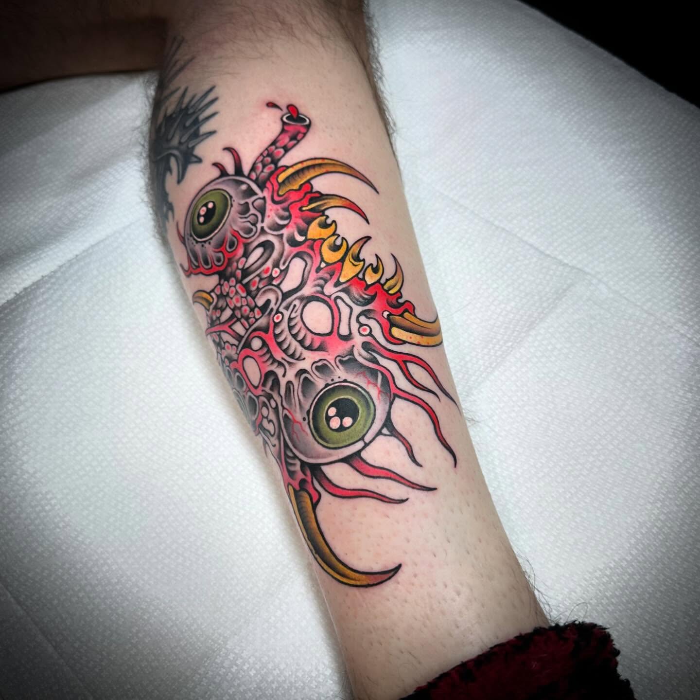 Alien creature geometric tattoo on the forearm by Mark Boller