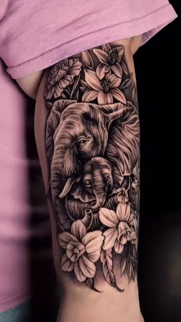 Elephants and flowers realism tattoo by Jack Alvarado.
