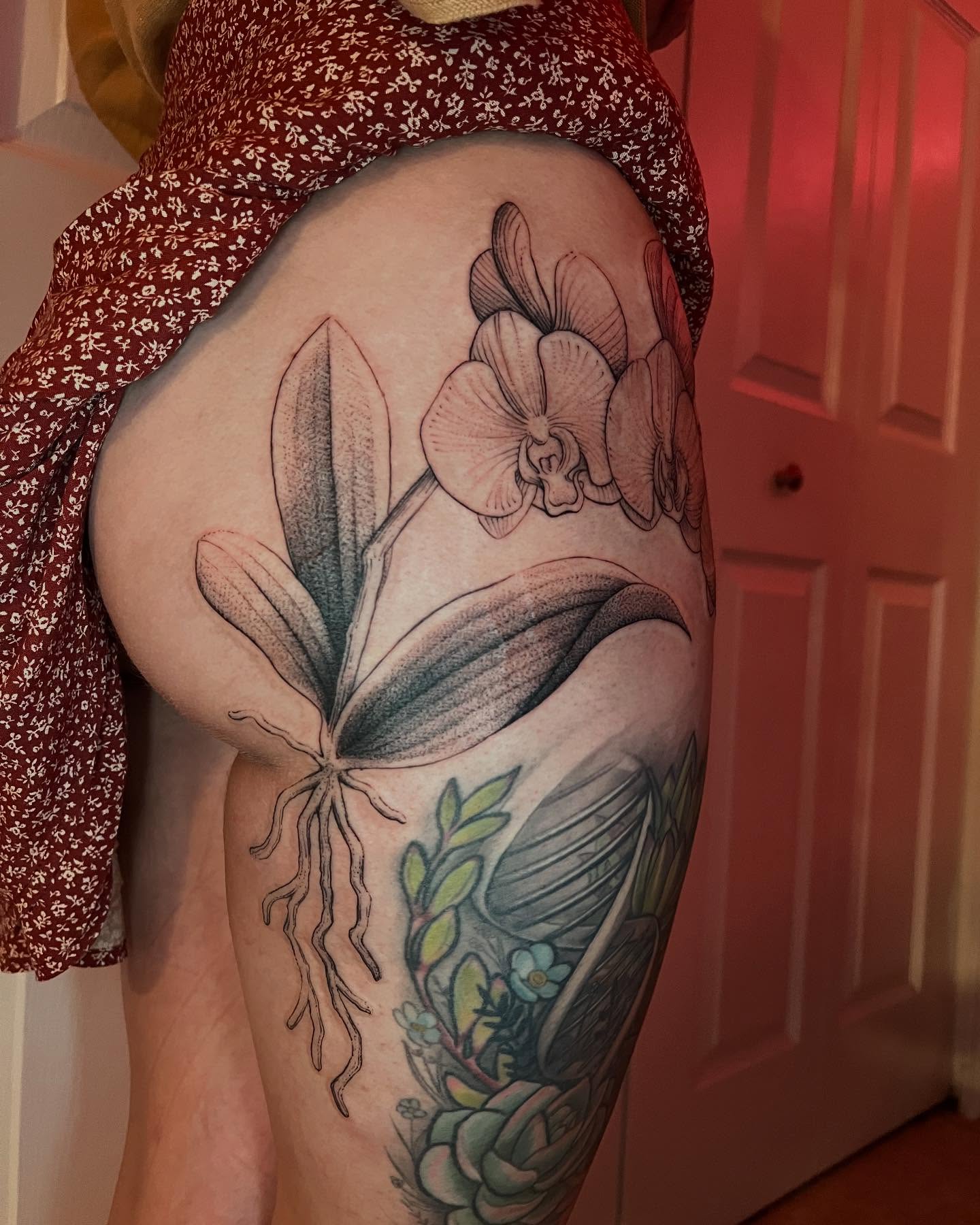 Orchid dotwork tattoo on the thigh by Natasha
