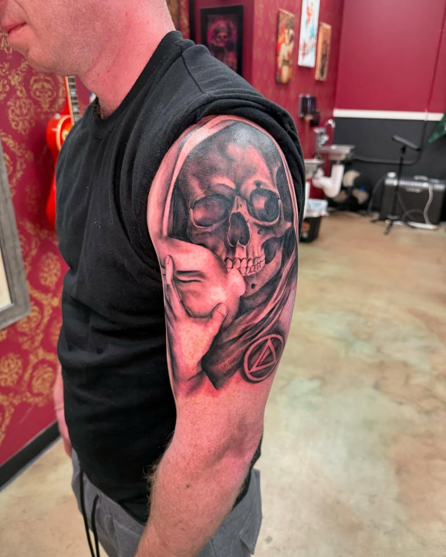 Skull and hand realism tattoo on the forearm by Shawn Cook