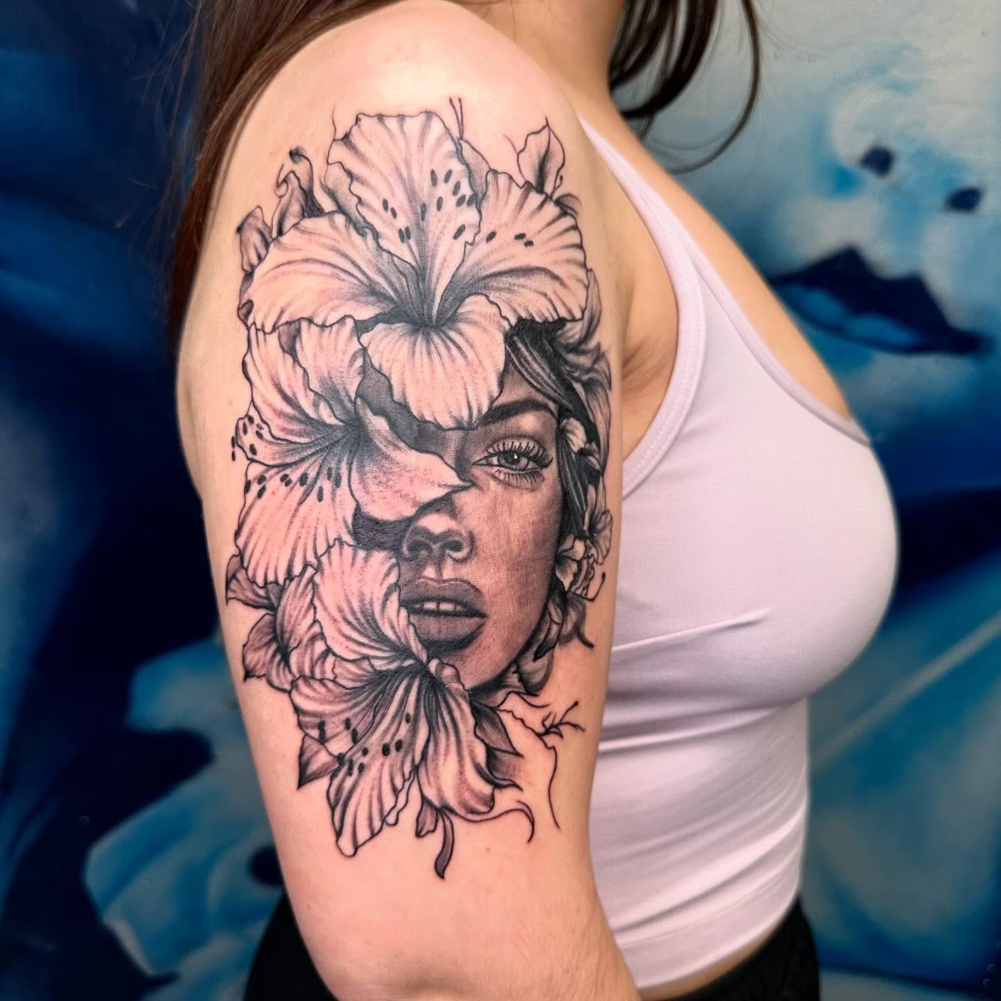Flower and woman realism tattoo on the shoulder by Kimberly landin