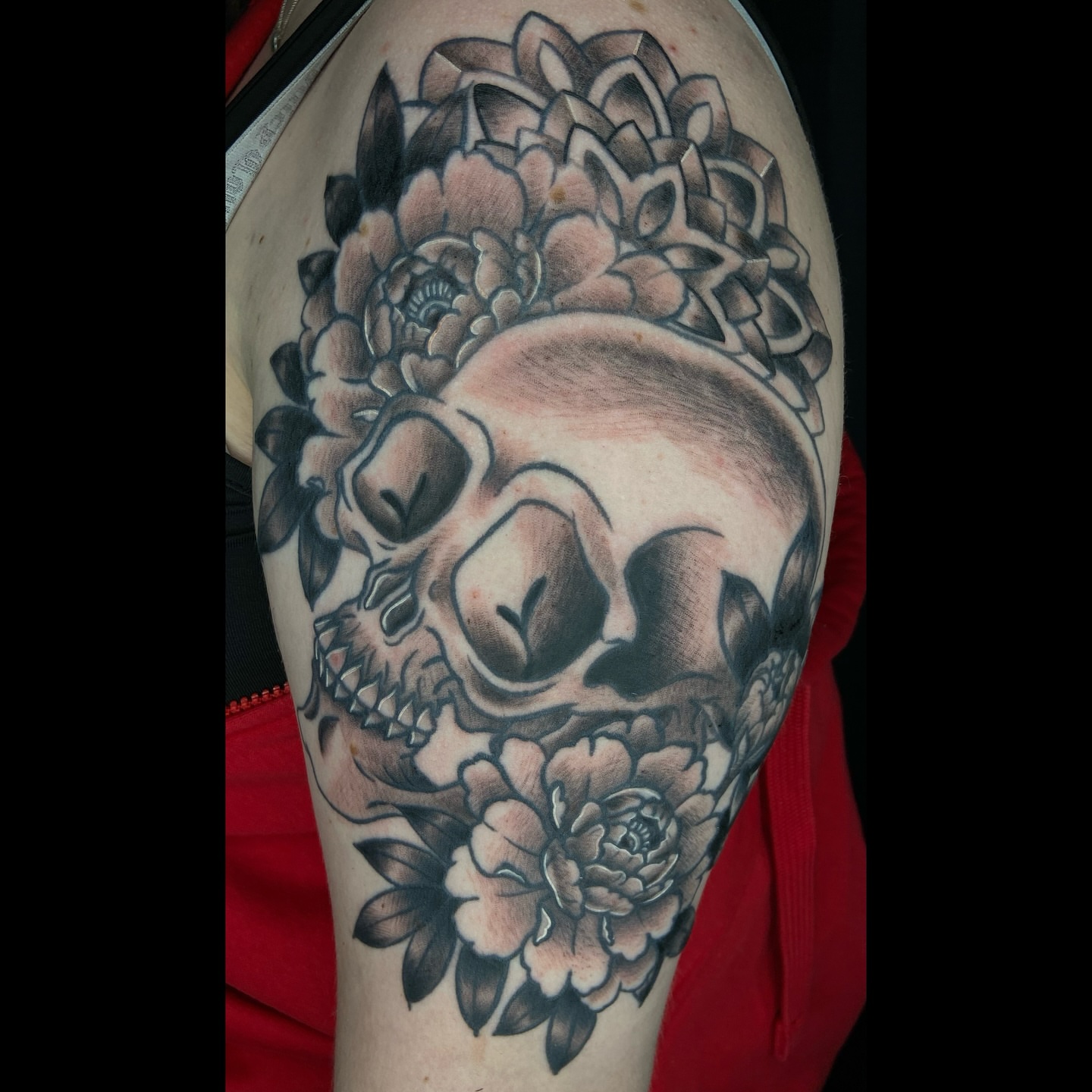 Skull and flowers realism tattoo on the forearm by Vincent Figuccio