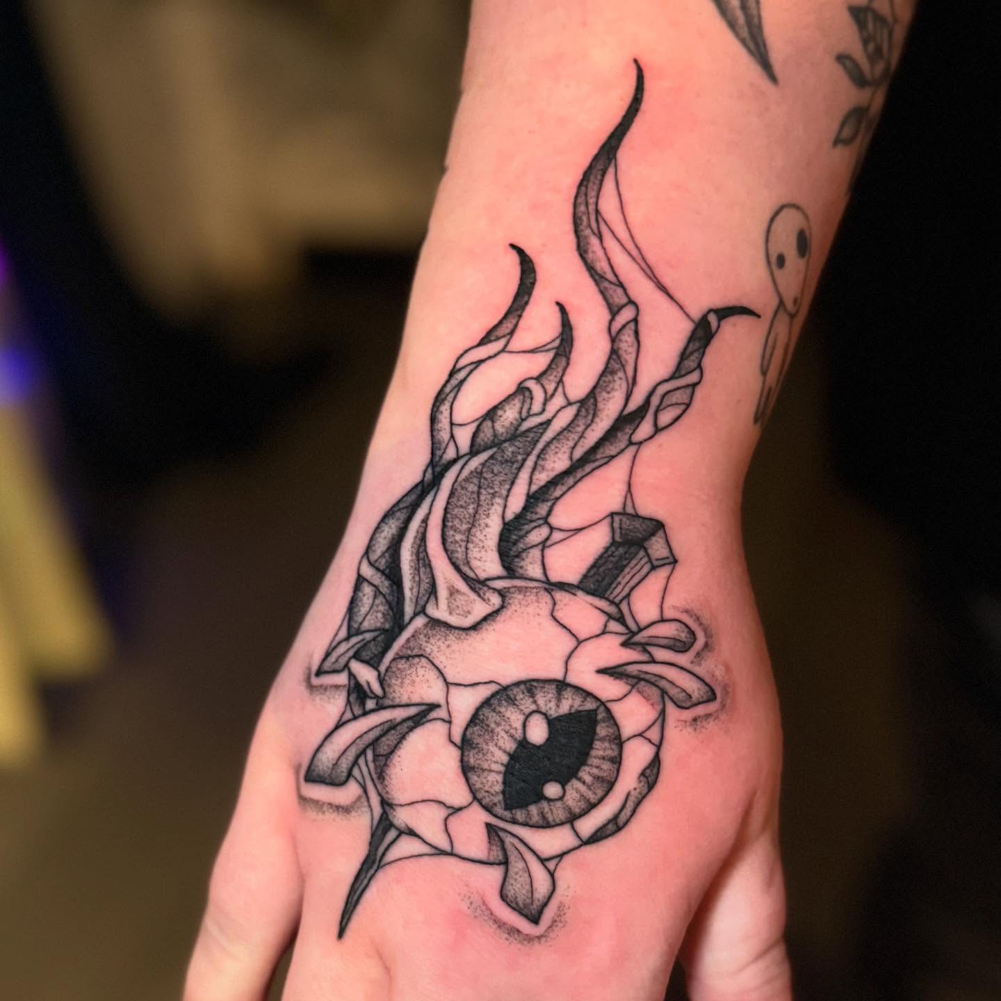 Eye with flames dotwork tattoo on the hand by Felicity