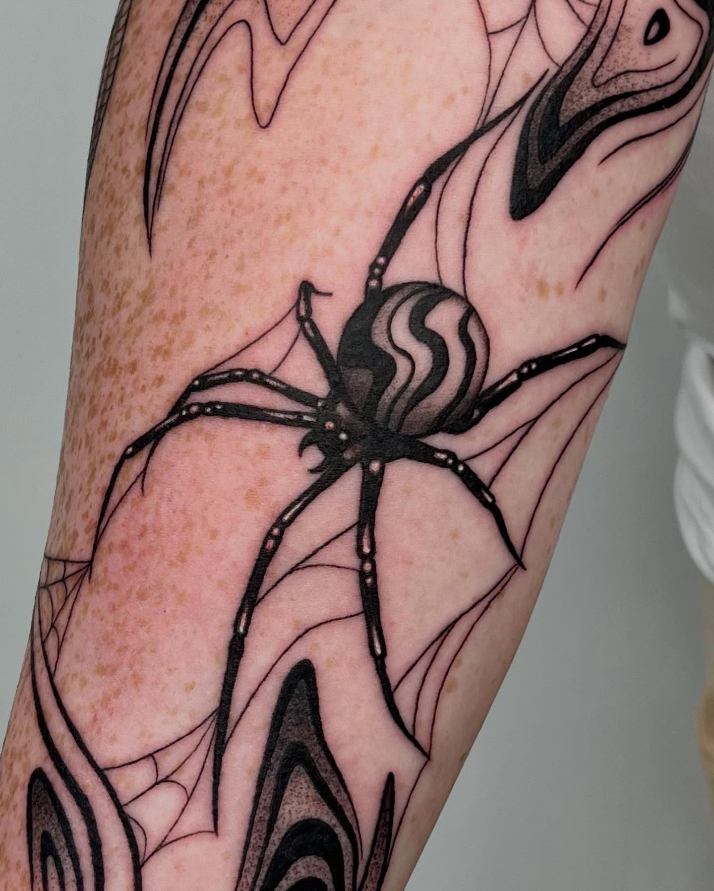 Spider black and grey tattoo on the forearm by Erin Blaney