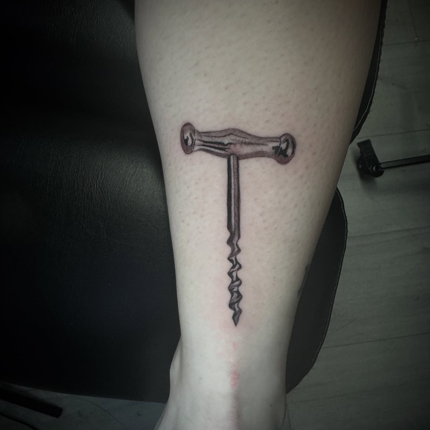 Corkscrew black and grey tattoo on the forearm by Chip