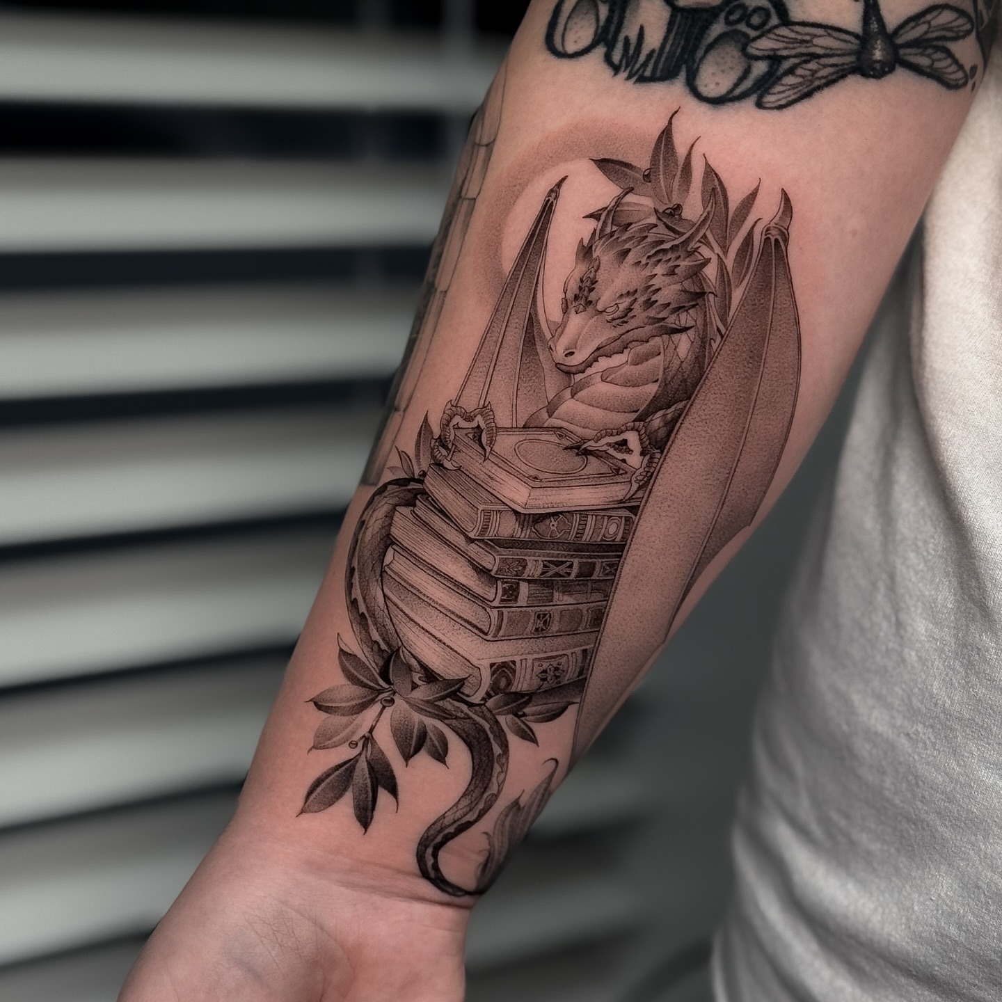 Dragon and books realism tattoo on the forearm by ♡ 𝕍𝕚𝕔𝕥𝕠𝕣𝕚𝕒 ℍ𝕠𝕝𝕞𝕖𝕤 ♡, Avon, Ohio