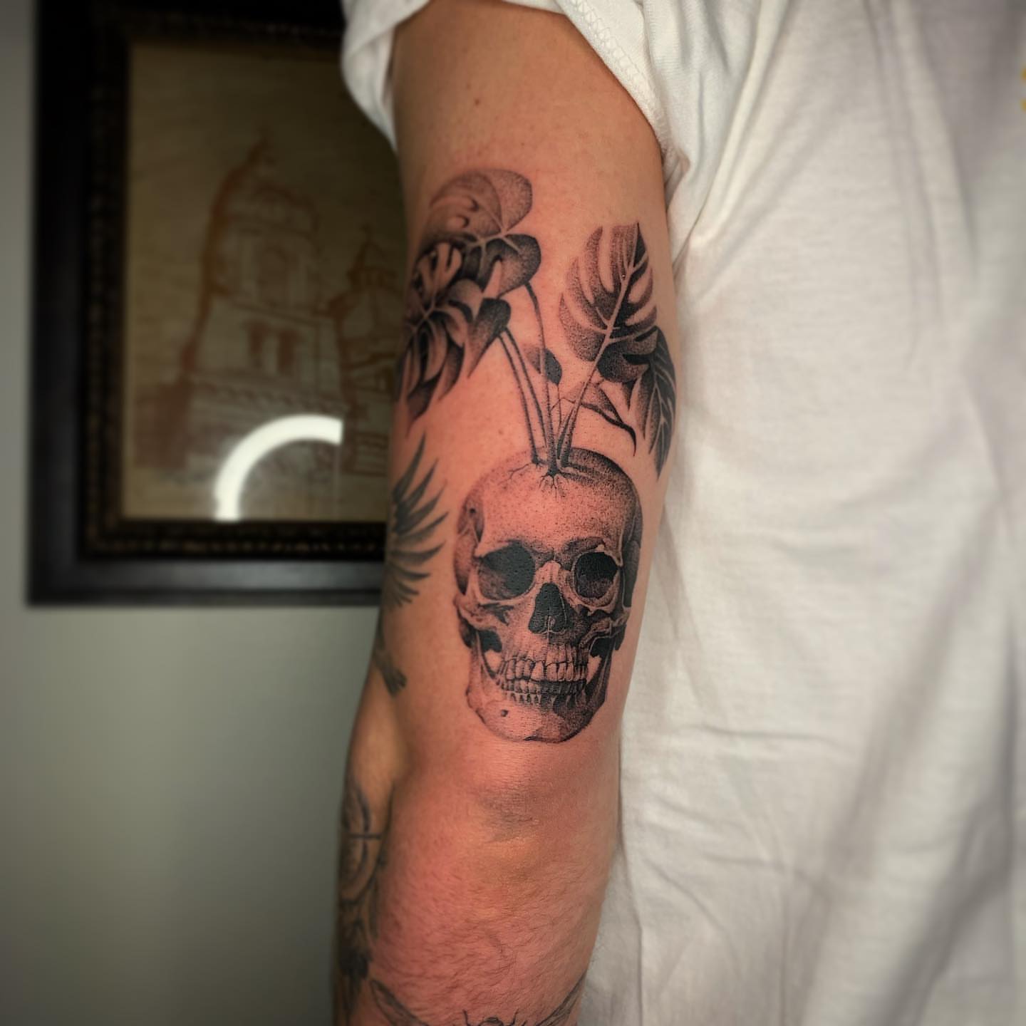 Skull with feathers realism tattoo on the forearm by Jacob Deirfield, Circleville, Ohio