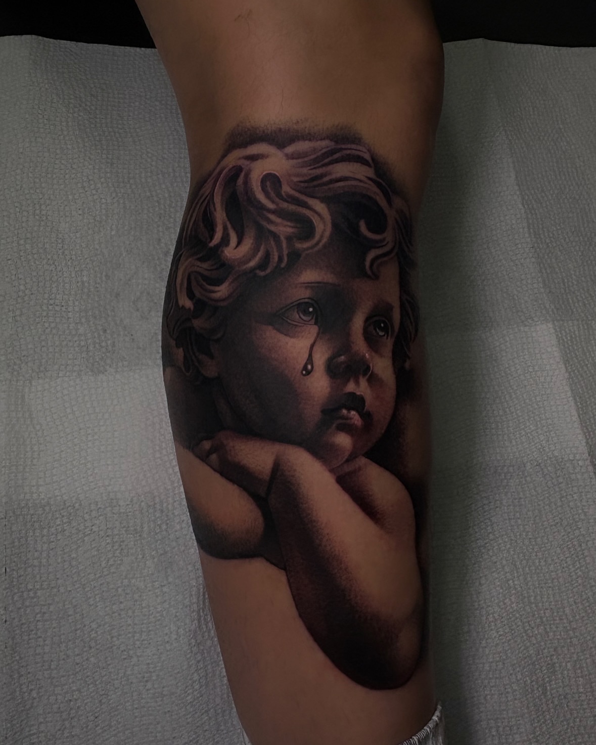 Child's head realism tattoo on the forearm by 𝖃𝖆𝖛𝖎𝖊𝖗 𝕬. 𝕾𝖆𝖑𝖎𝖓𝖆𝖘