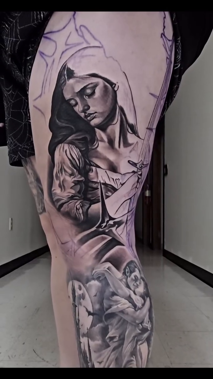 Woman with angelic figures realism tattoo by Tyler Malek