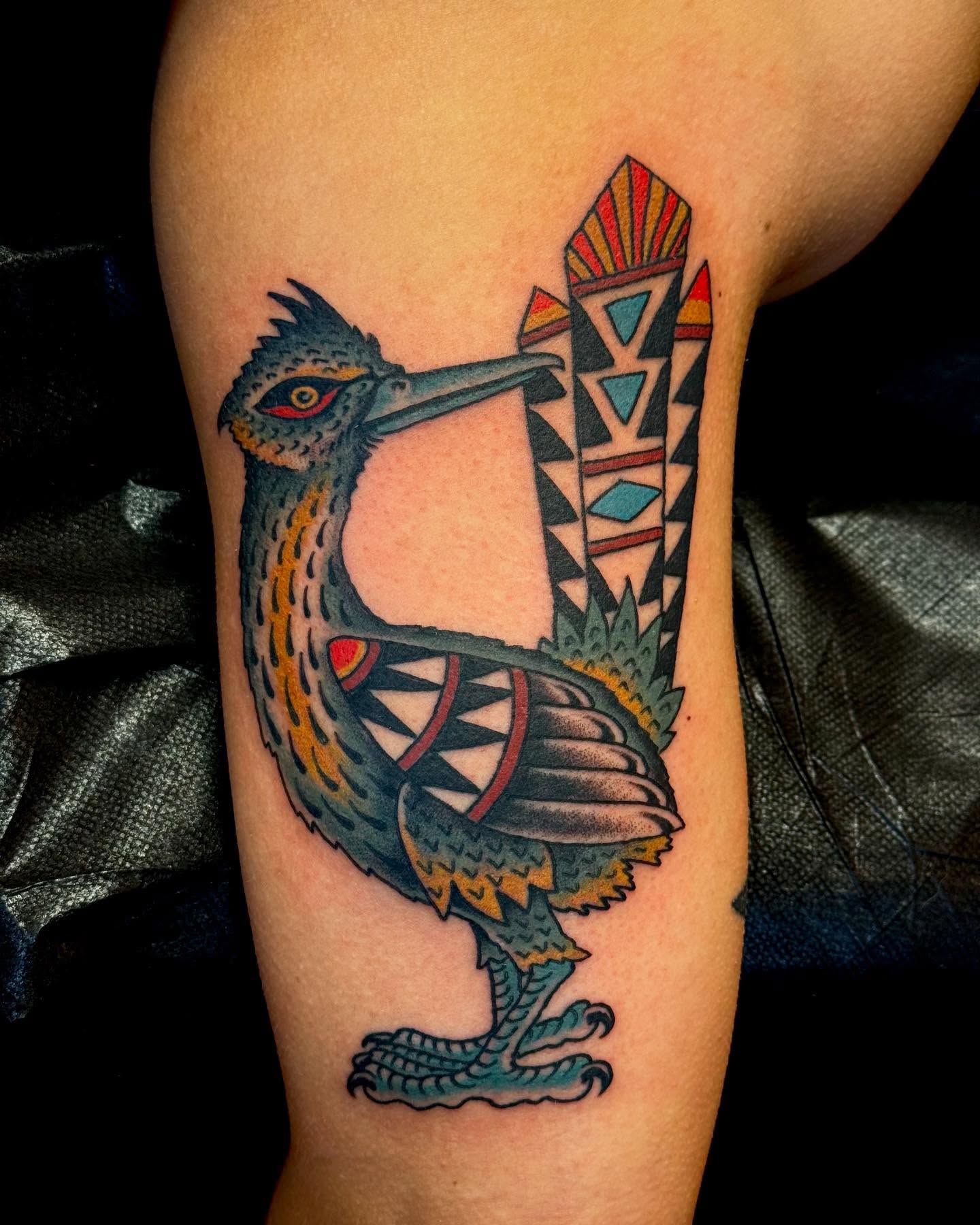 Bird with geometric patterns American traditional tattoo on the forearm by Nick Rodin