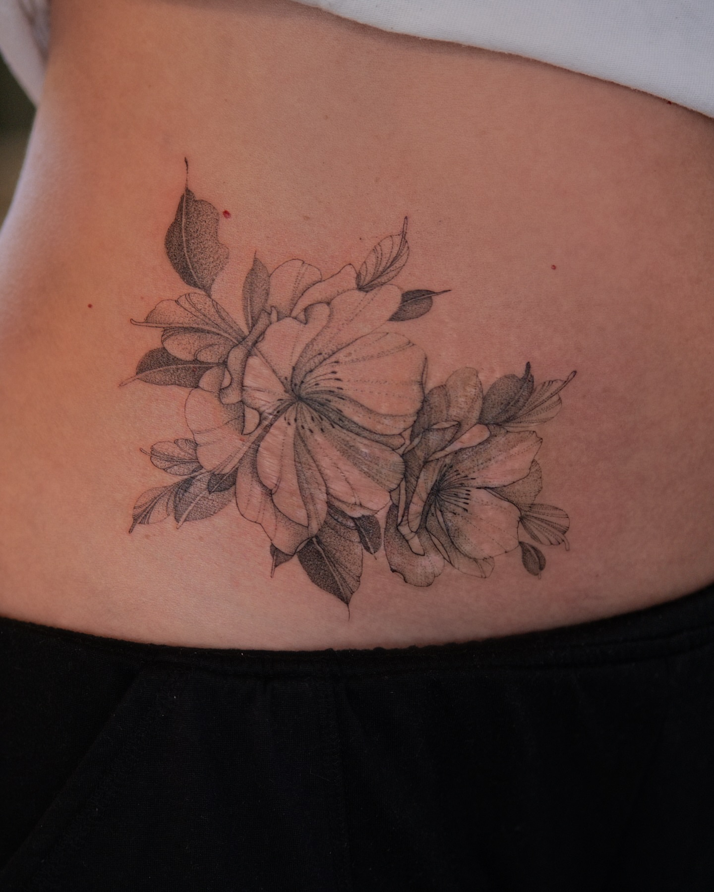 Flowers black and grey tattoo on the torso by Flower Tattoo Sf