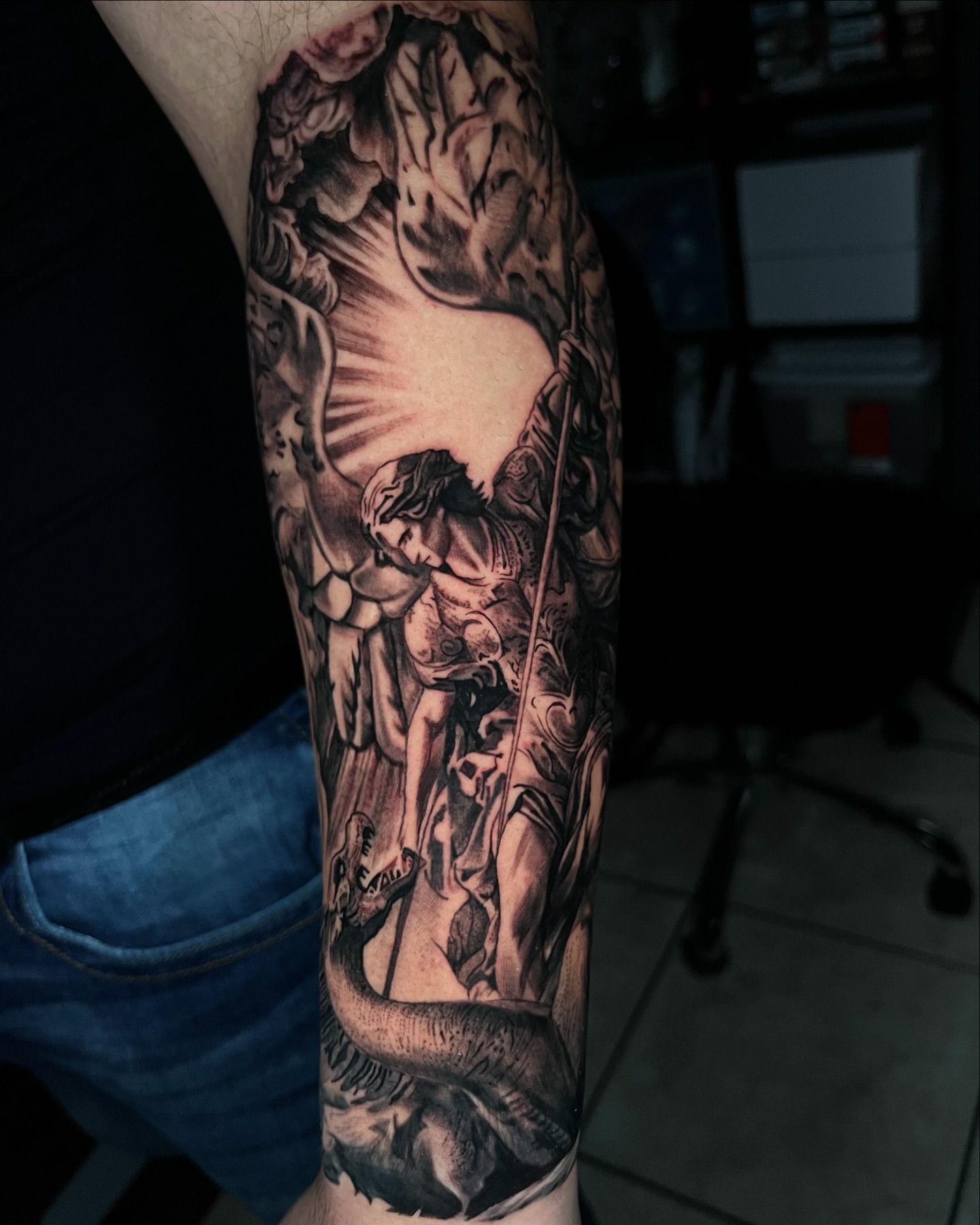 Saint and serpent realism tattoo on the forearm by Angie Morales, Laredo, Texas