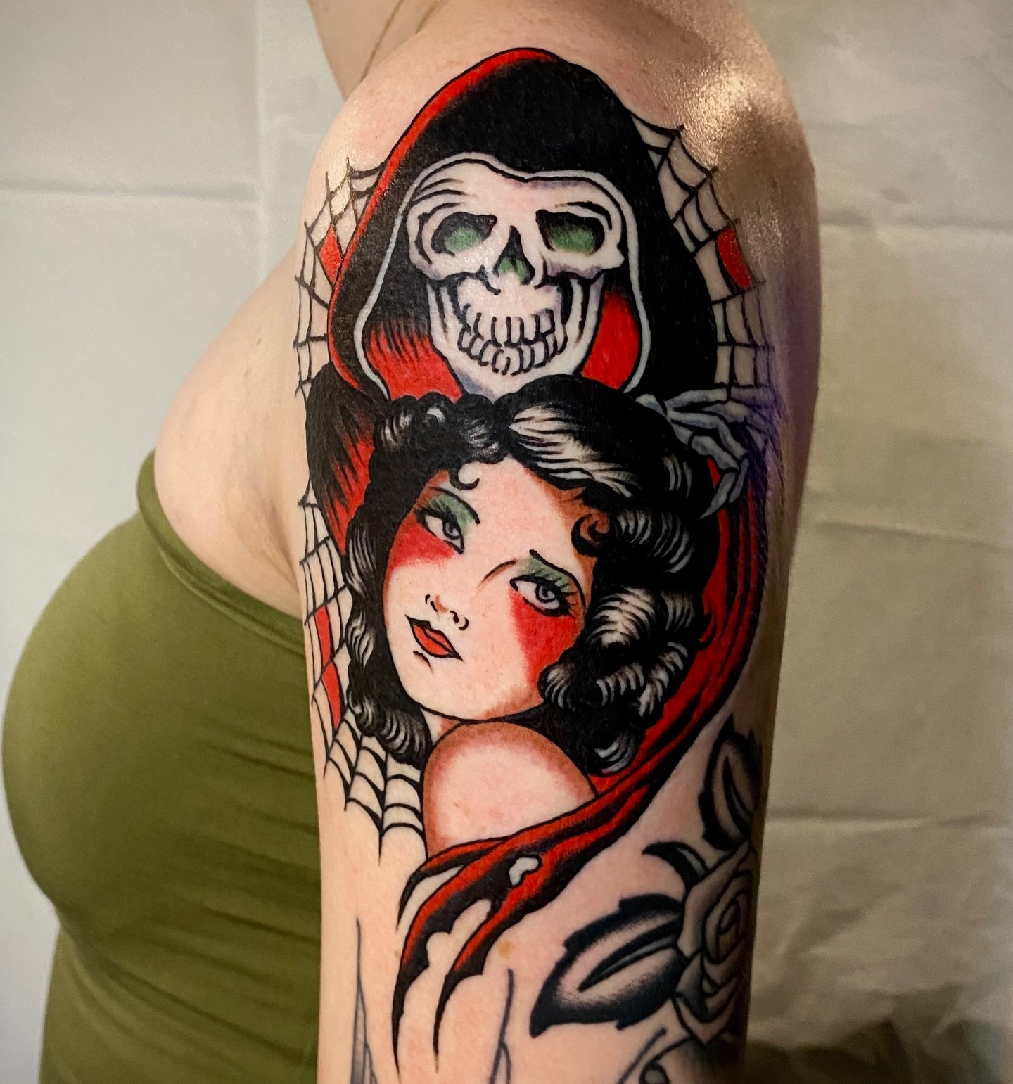 Woman with skull American traditional tattoo on the forearm by Haley Tucker, Sebastopol, California