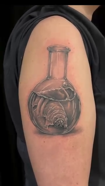 Tardigrade in a flask realism tattoo by Blake Van Vleck