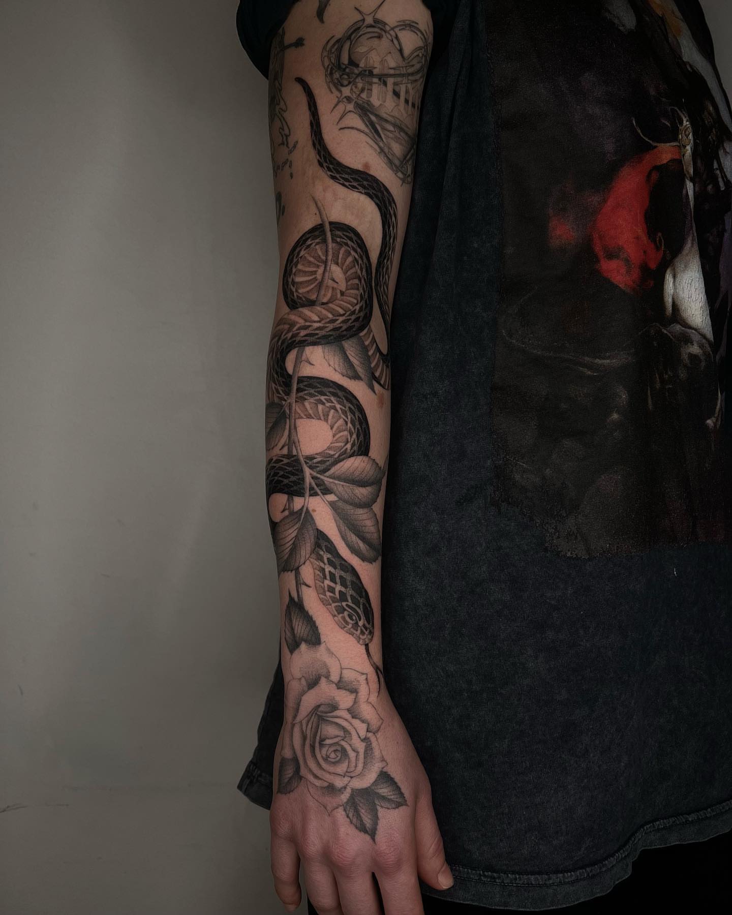 Snake and rose realism tattoo on the forearm by linahsiaotattoo
