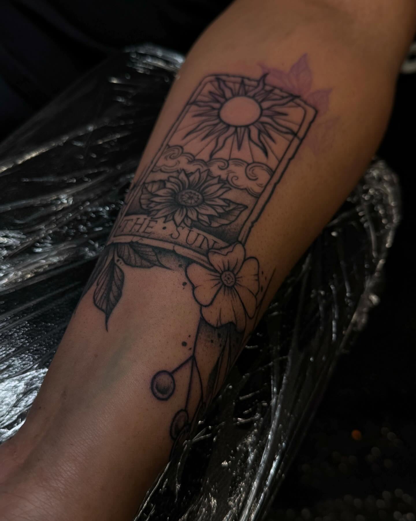 The sun tarot card black and grey tattoo on the forearm by Gabby Finearts