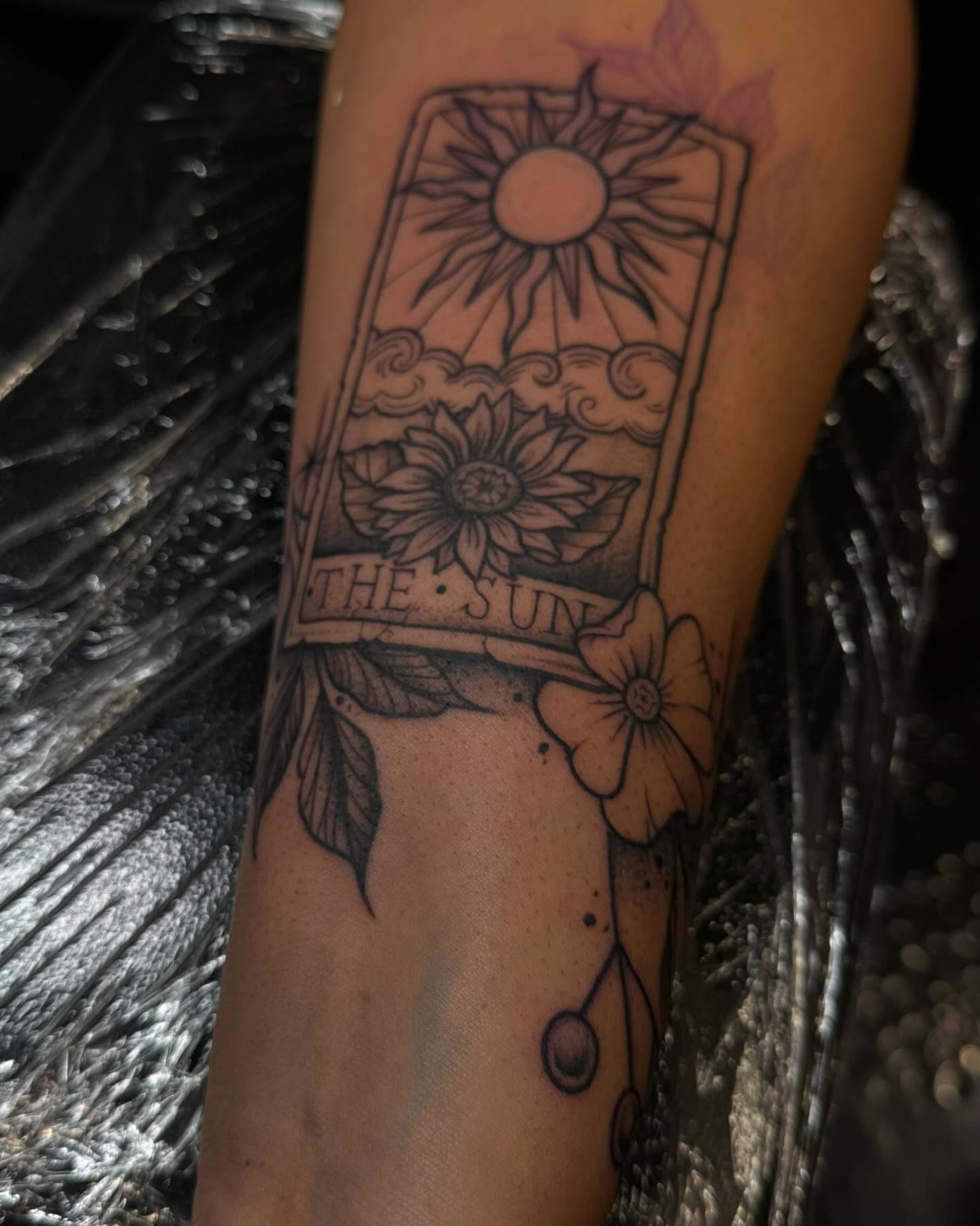 The sun tarot card black and grey tattoo on the forearm by Gabby Finearts