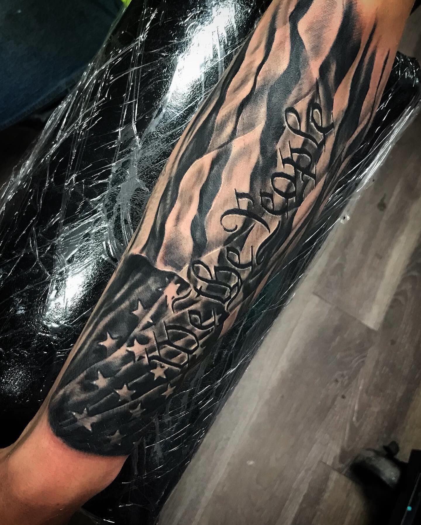 American flag and text American traditional tattoo on the forearm by Tonii Florrez
