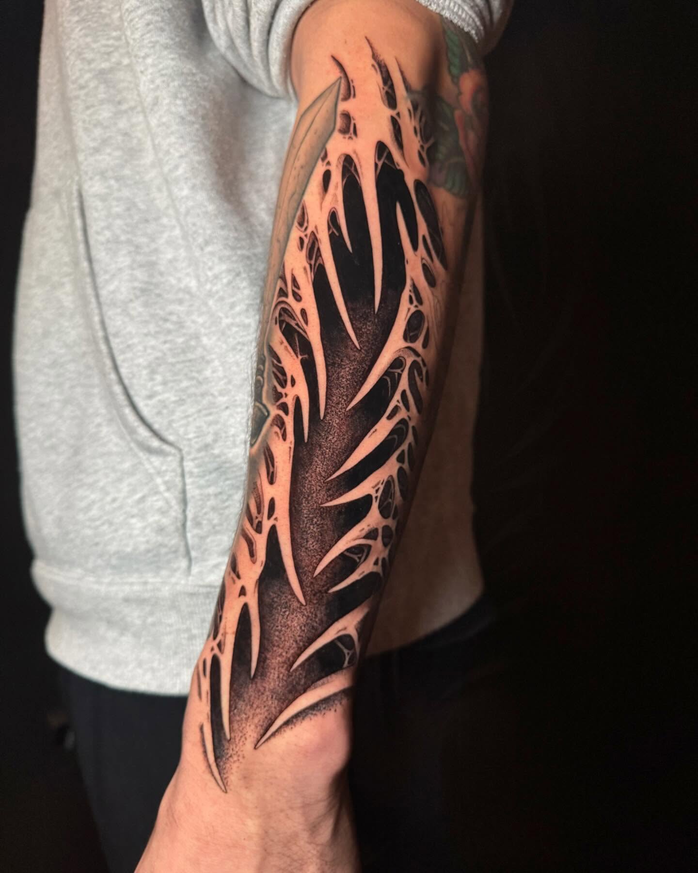 Spiky flame geometric tattoo on the forearm by Dylan Orbock, Berkeley, California