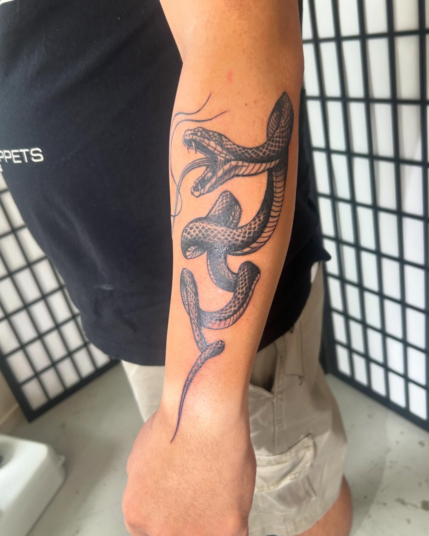 Snake black and grey tattoo on the forearm by ɢɢ sᴛʏʟᴇs