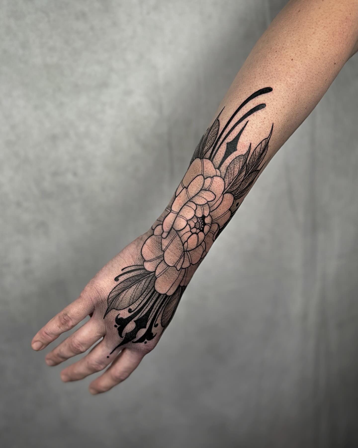 Floral black and grey tattoo on the forearm by Mallory Miller π³οΈβπ Eugene