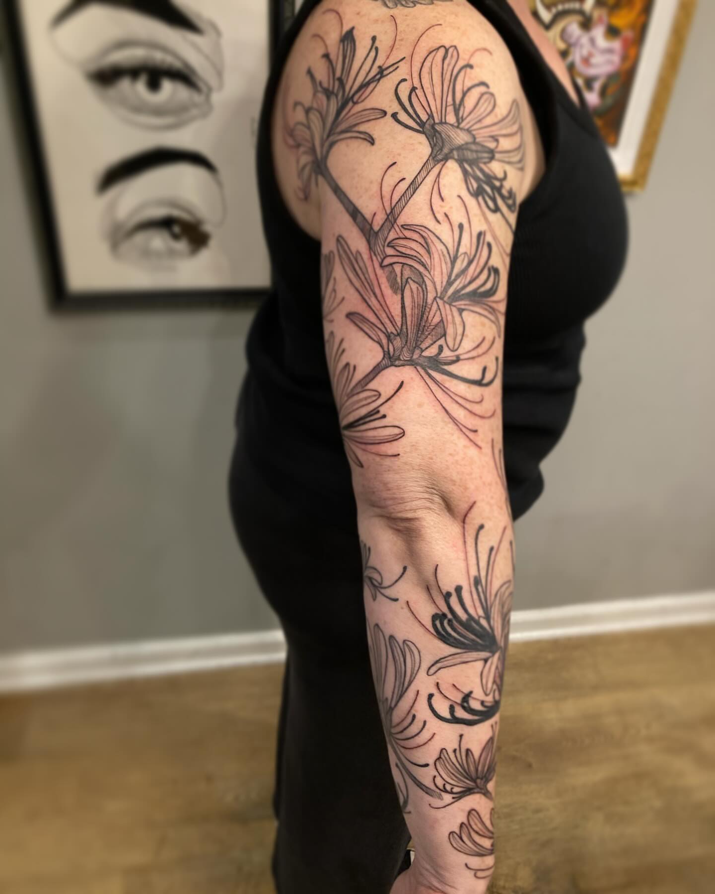 Floral arrangement black and grey tattoo on the forearm by Rizzie D'Alterio