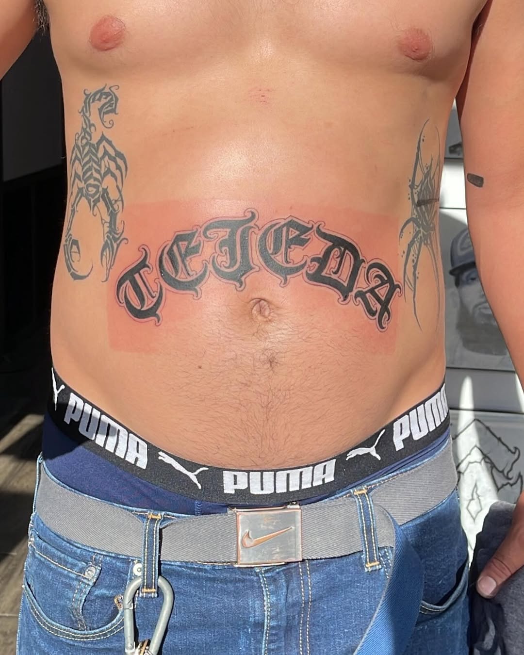 Old English lettering Chicano tattoo on the torso by Renzoe_piercingz