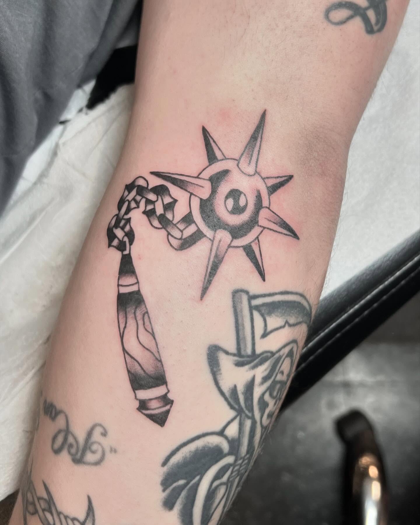 Star and chain black and grey tattoo on the forearm by Erika Donn, Portland, Oregon